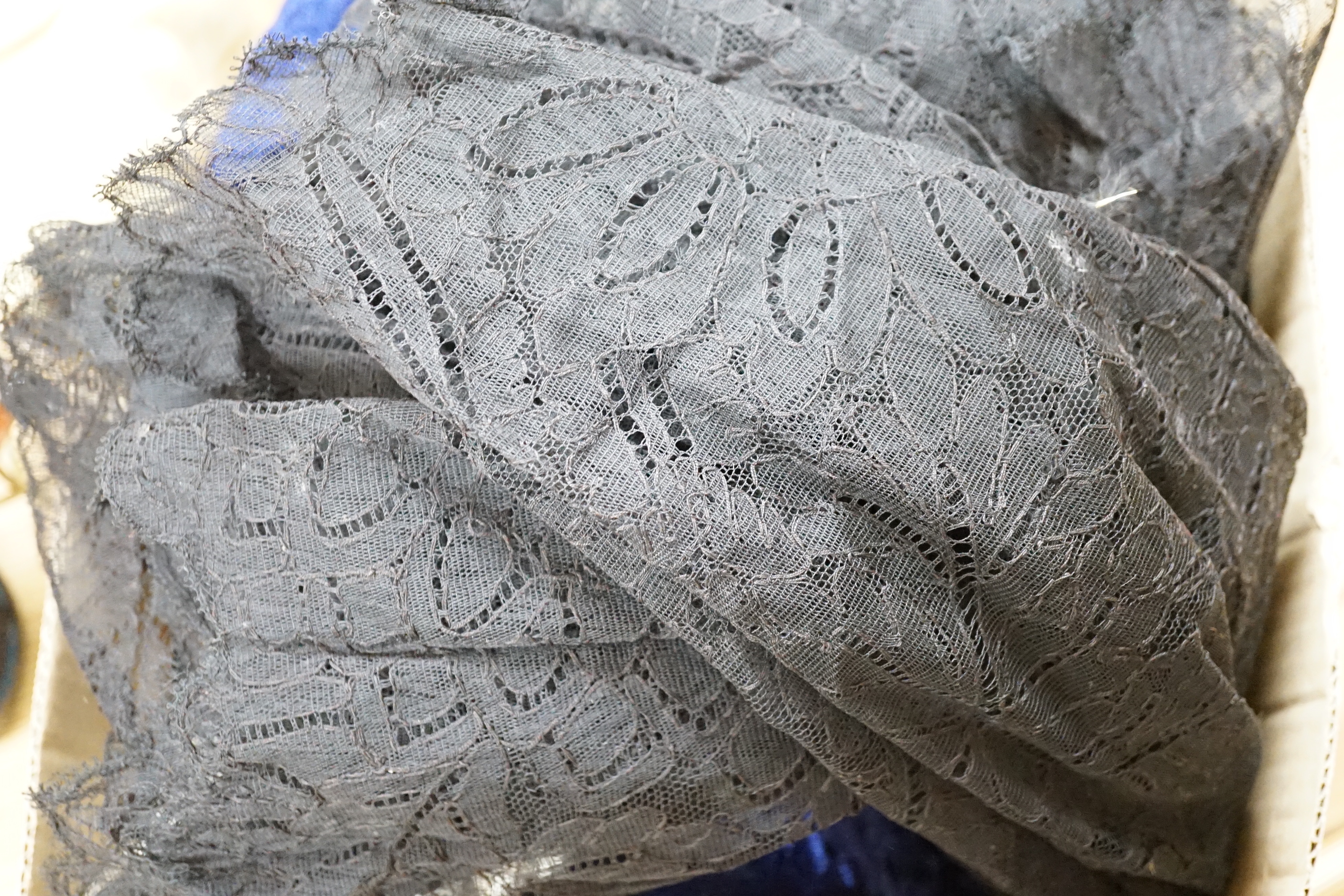 A large black lace veil, a blue velvet cape etc